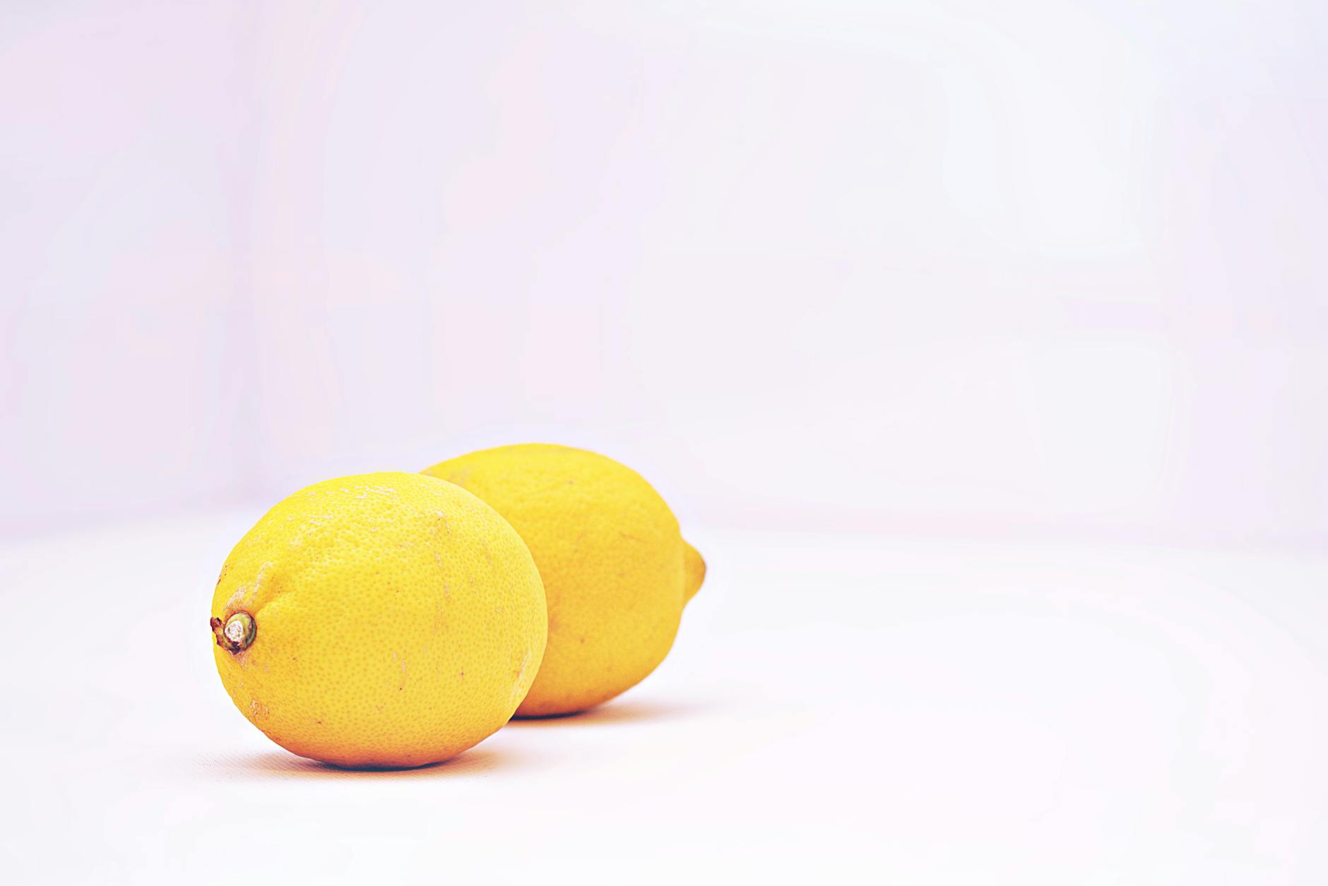 Hands holding pastel-colored silicone clitoral vibrators for body-positive pleasure