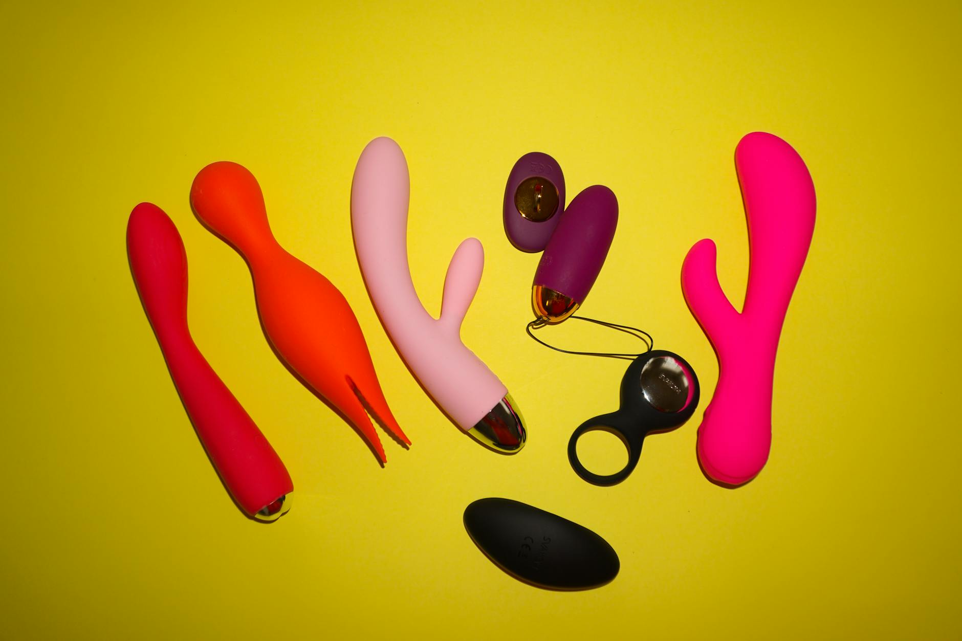 Intimate close-up of hands holding a blue silicone vibrator, representing self-pleasure and reconnection