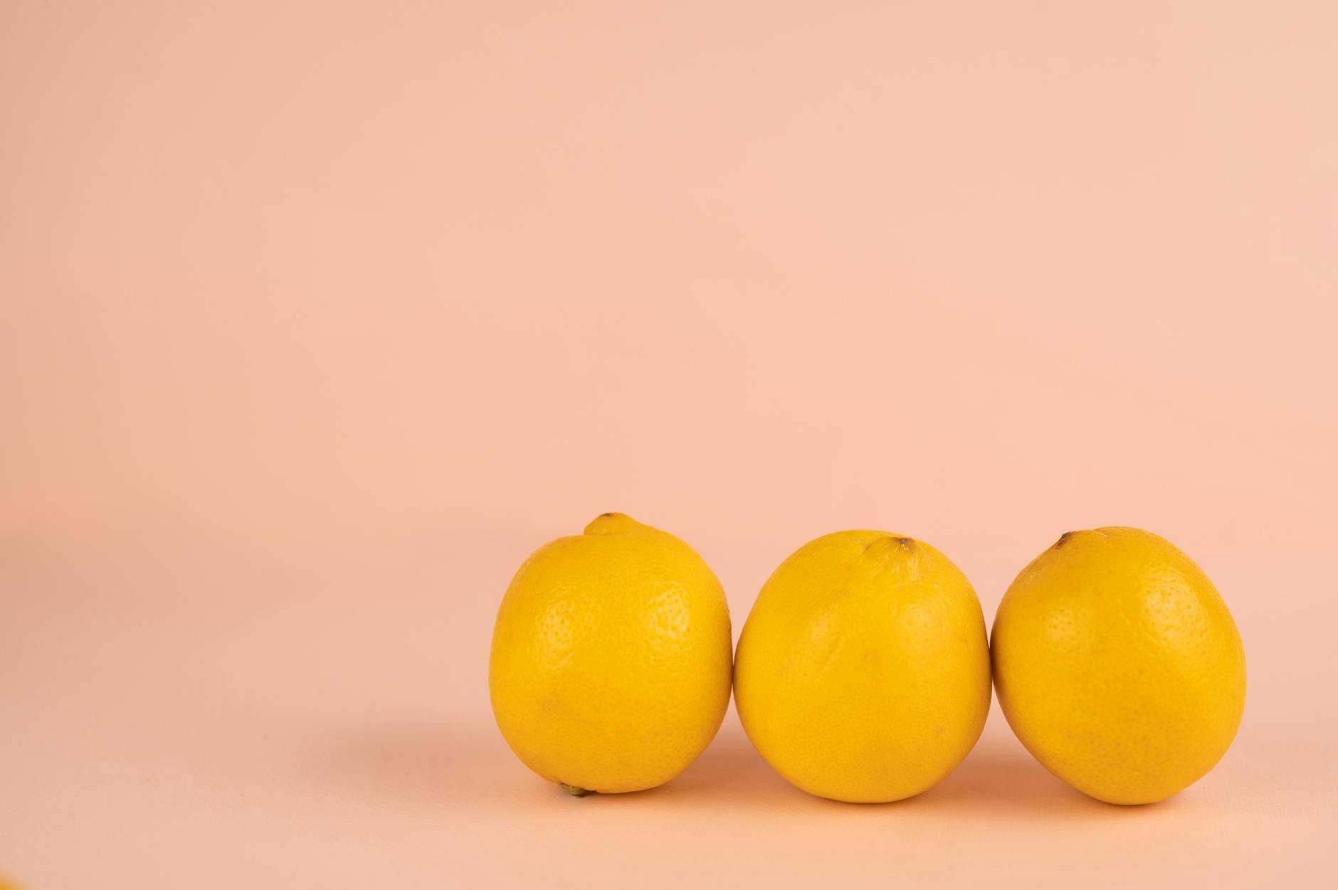 Bright ripe lemons on a pastel background, symbolizing renewed energy and fresh starts.